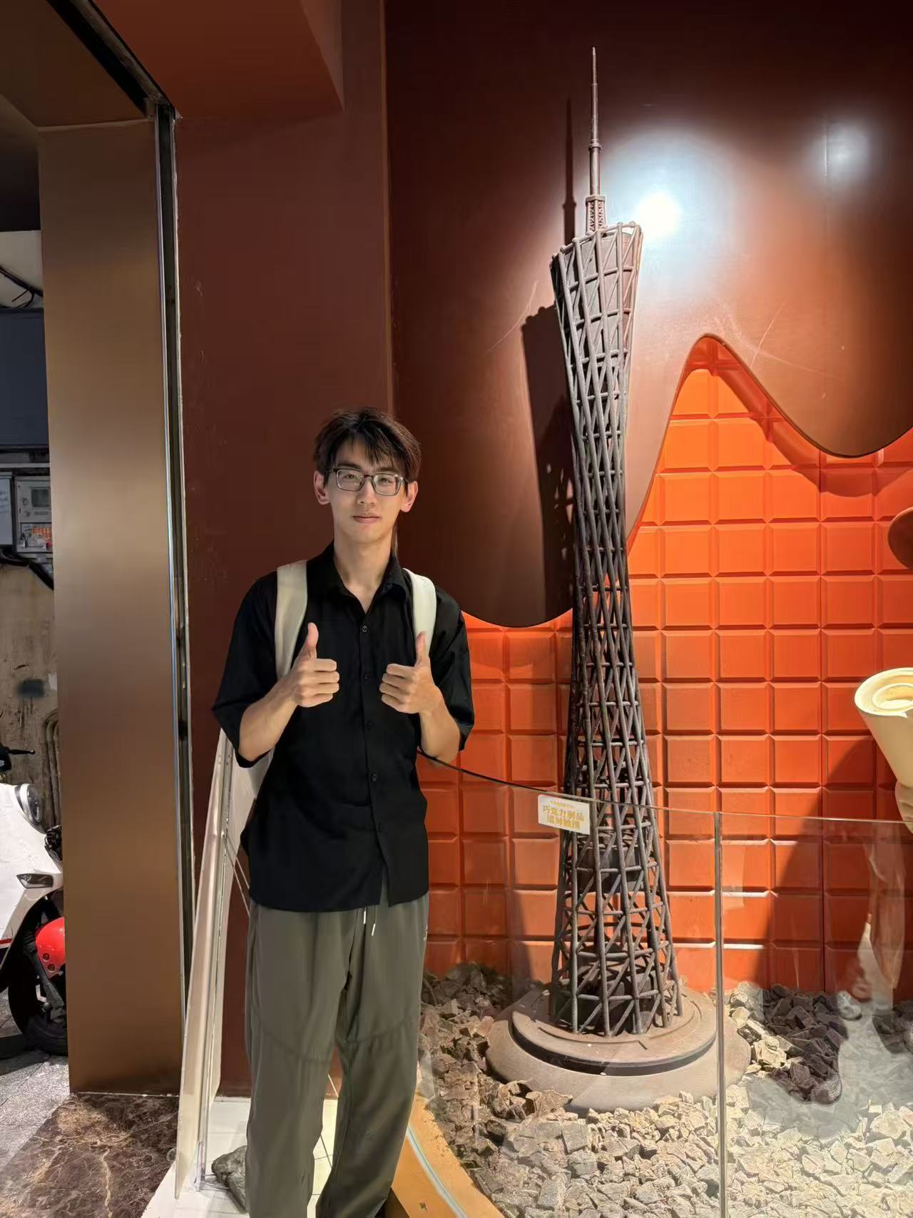 Summer camp portrait beside a model of Guangzhou Tower